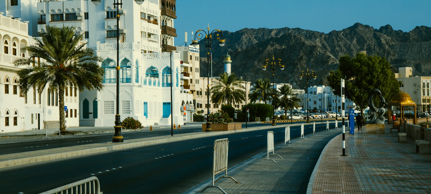 Mutrah Corniche in Muscat, white façades and palm trees along the sea