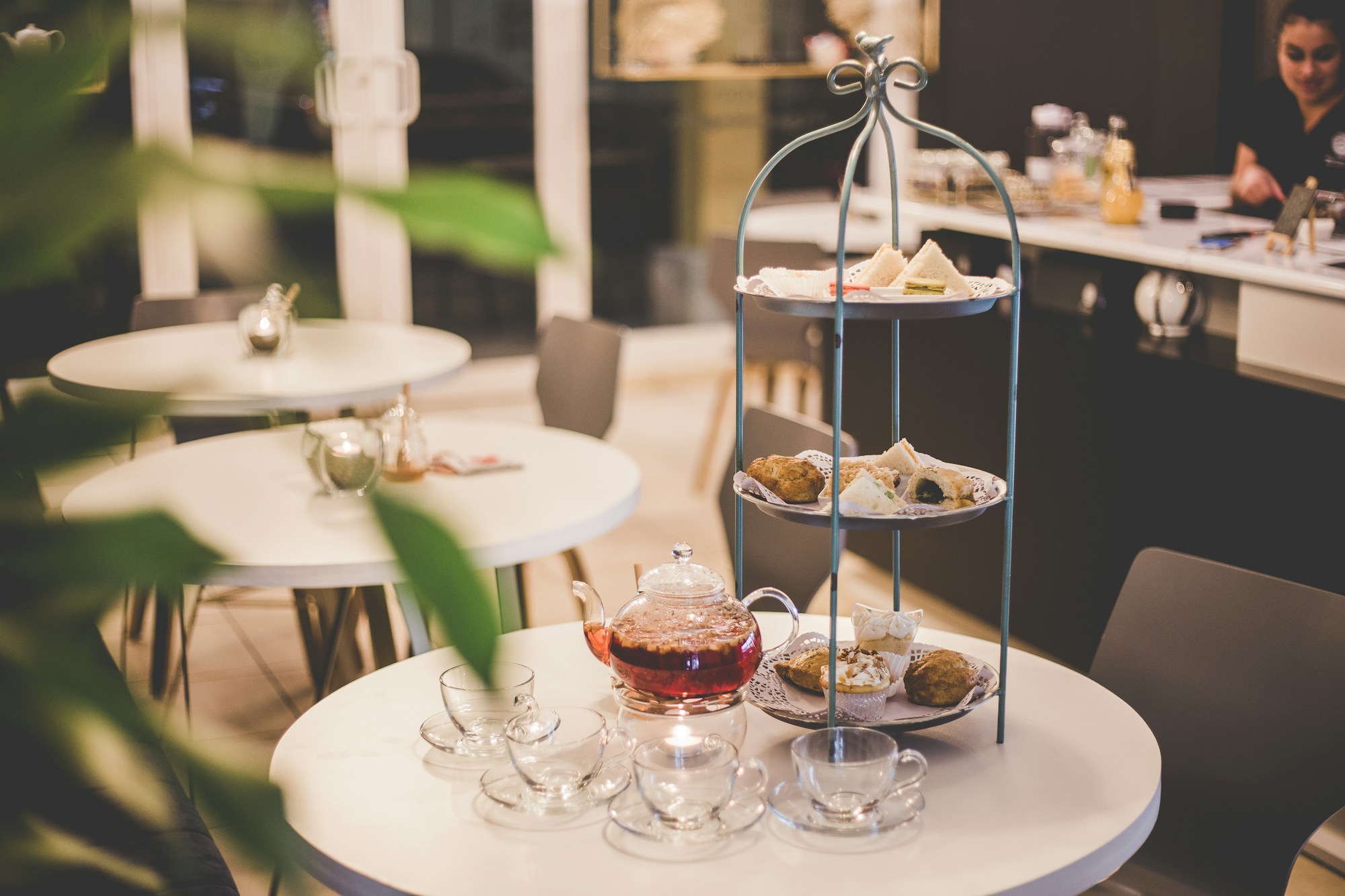 Three-tier afternoon tea stand on a round white table