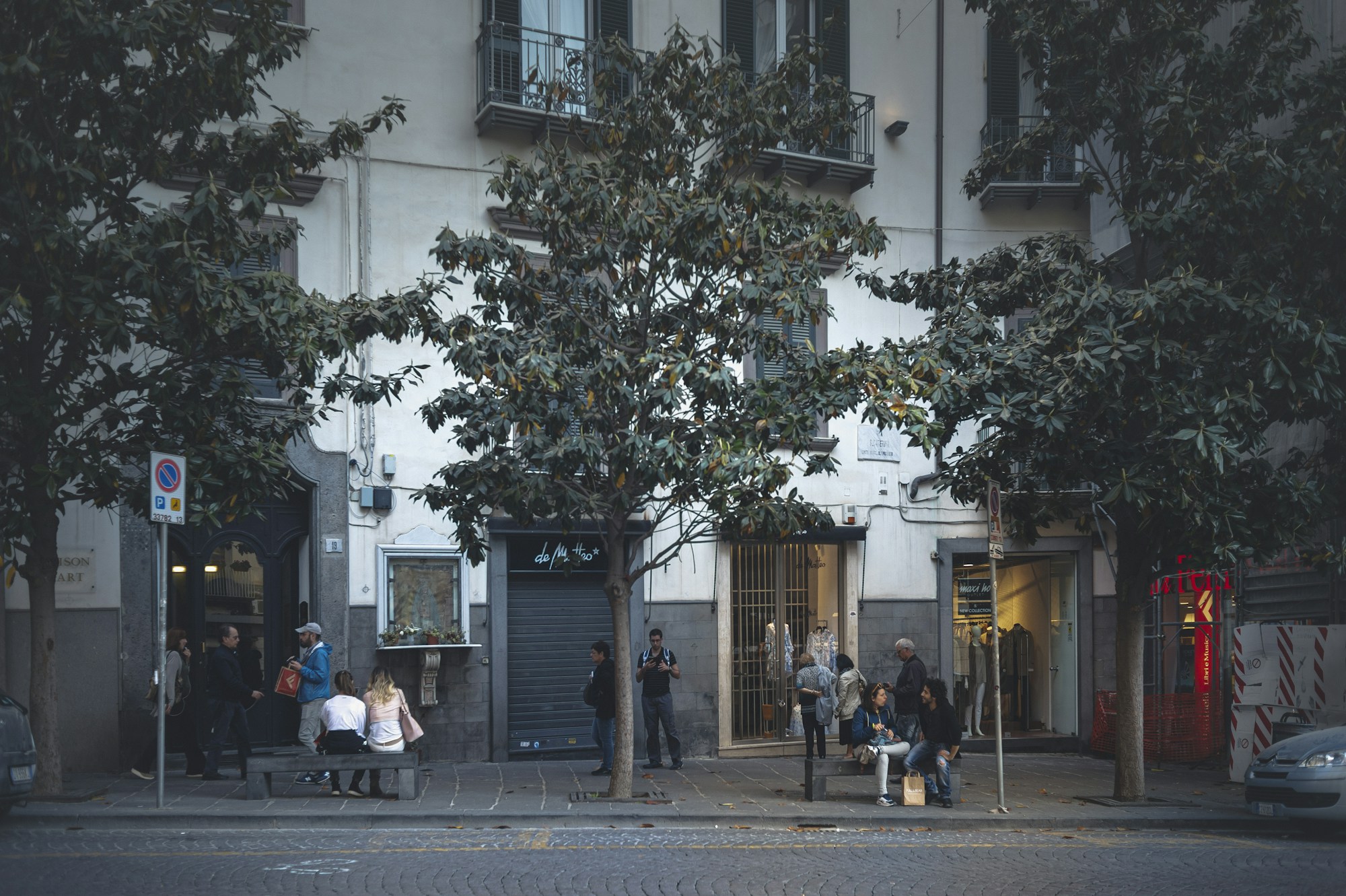 Busy street in central Naples, city-centre buildings and passers-by