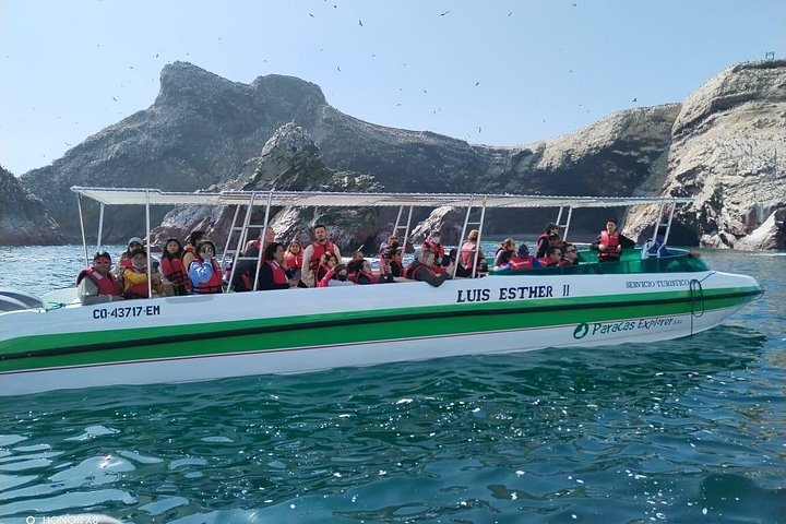 Covered speedboat heading toward the Ballestas Islands