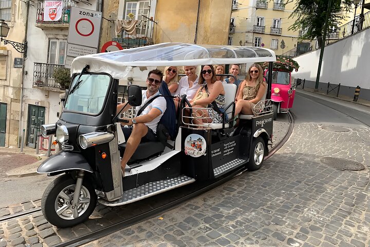 Electric tuk-tuk on a Lisbon street with its guide