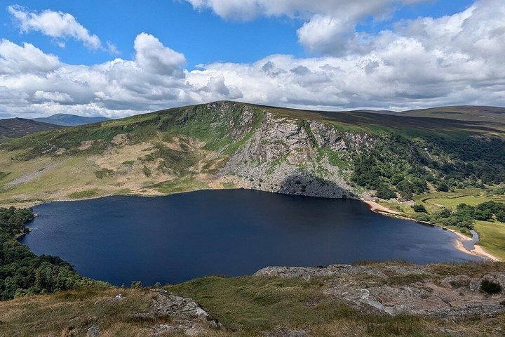 Mountain road through the Wicklow uplands with a lake below