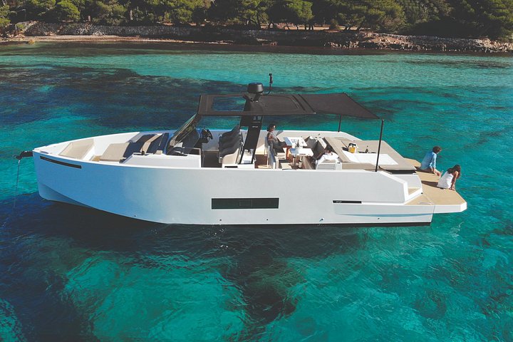 Private white yacht anchored in turquoise water