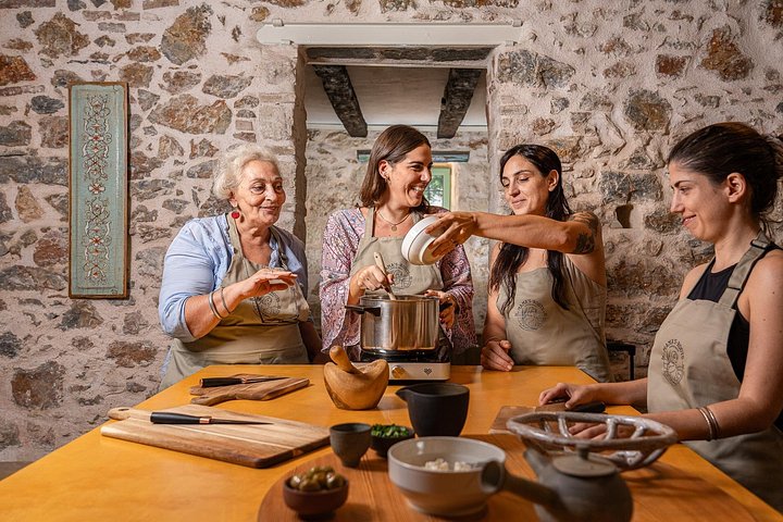 Family-style meal in a garden after a Greek cooking class in Athens