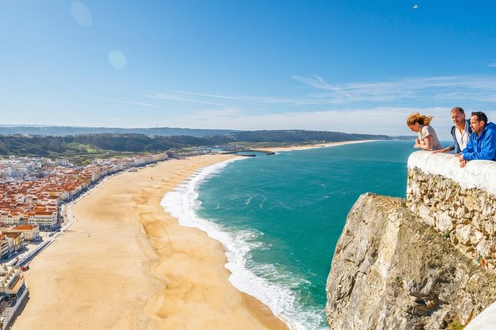 Viewpoint over the sandy beach and surf at Nazare, with the coastline curving away