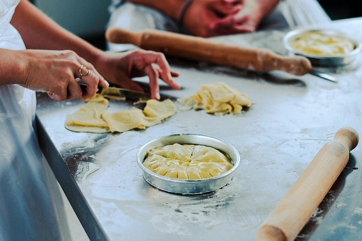 Making phyllo dough during a Greek cooking class on a rooftop in Athens