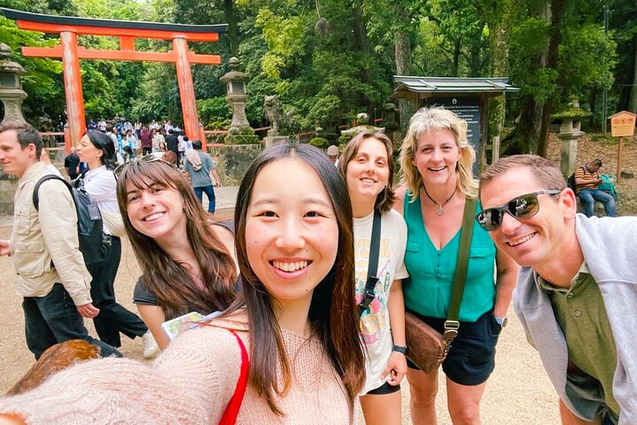 Group of visitors walking along a path in Nara Park