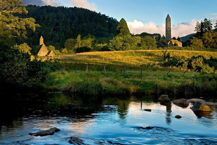 Green valley and lake at Glendalough under low cloud