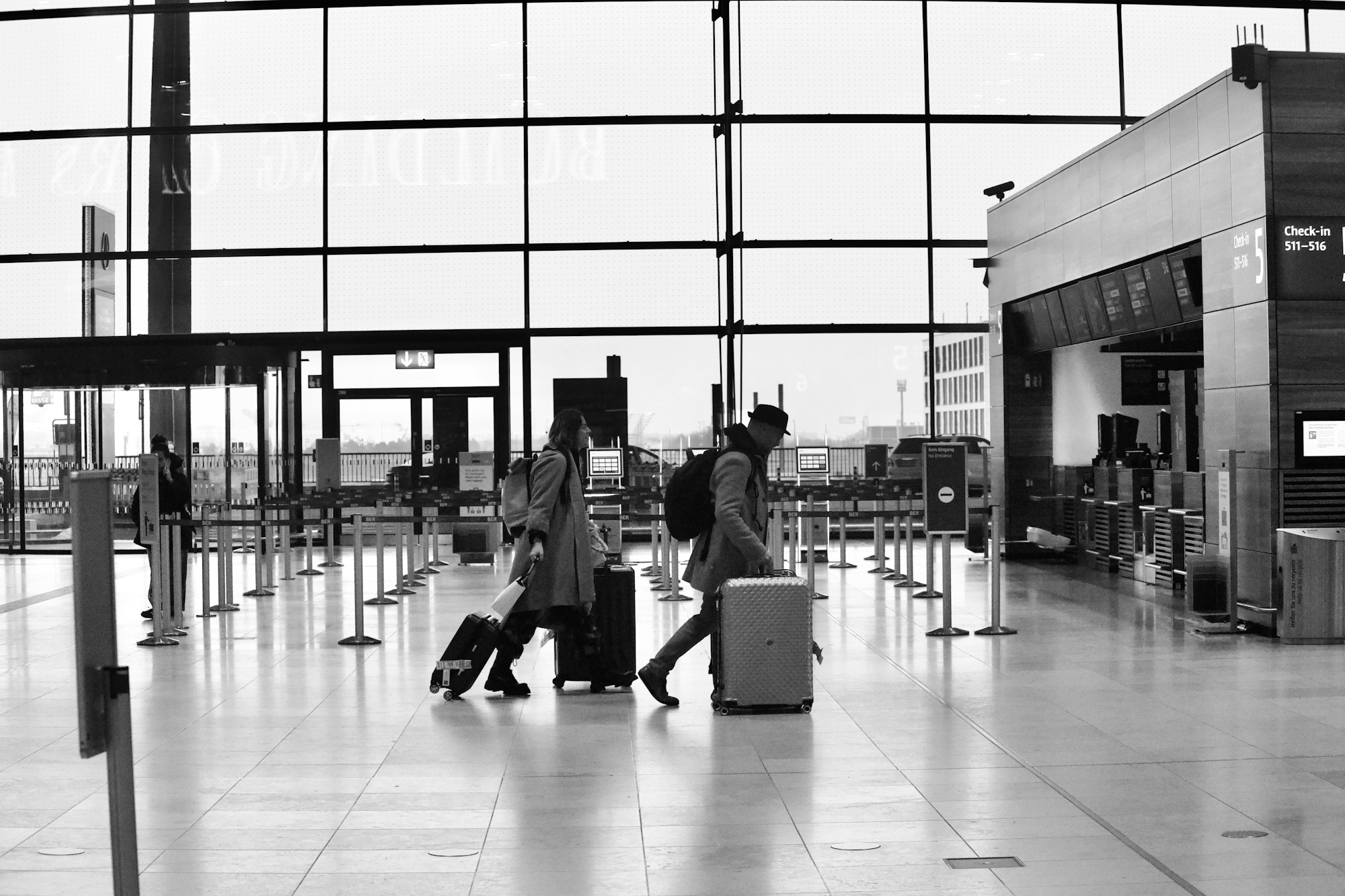 Family travelling through an airport with suitcases