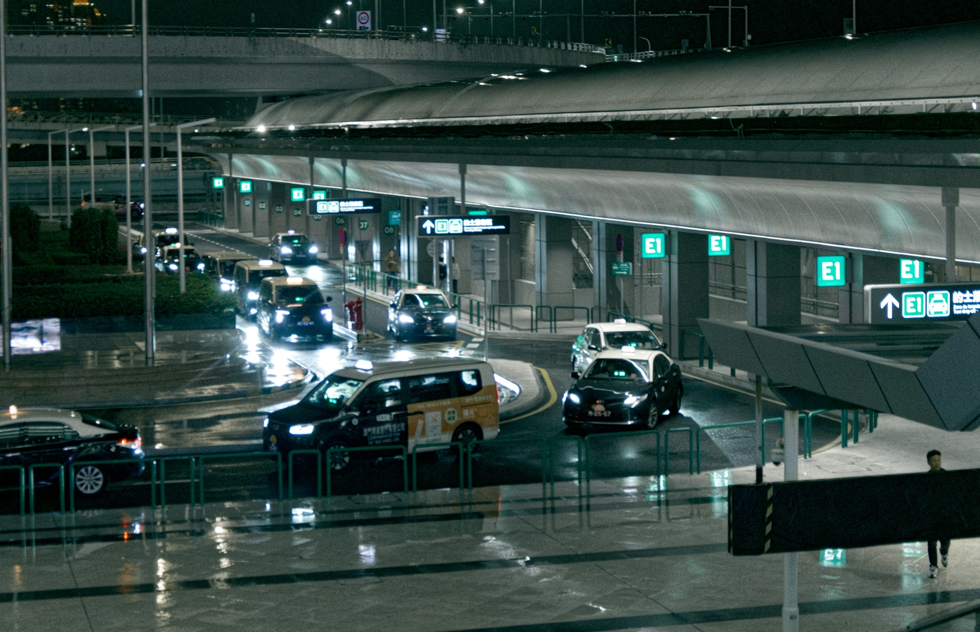 Taxi queue outside an Asian airport terminal