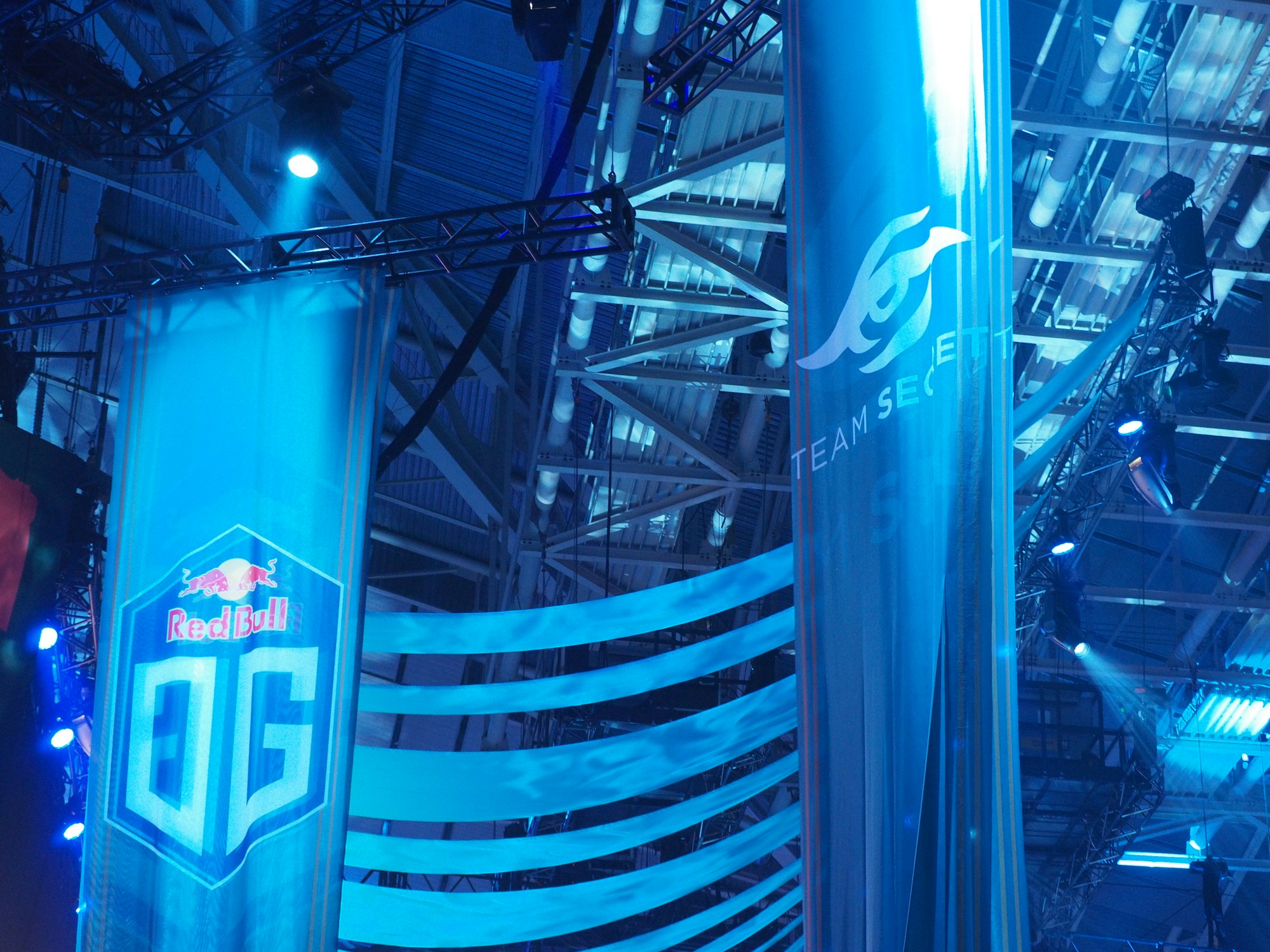 Banderolas azules con logotipos de equipos en un evento de esports
