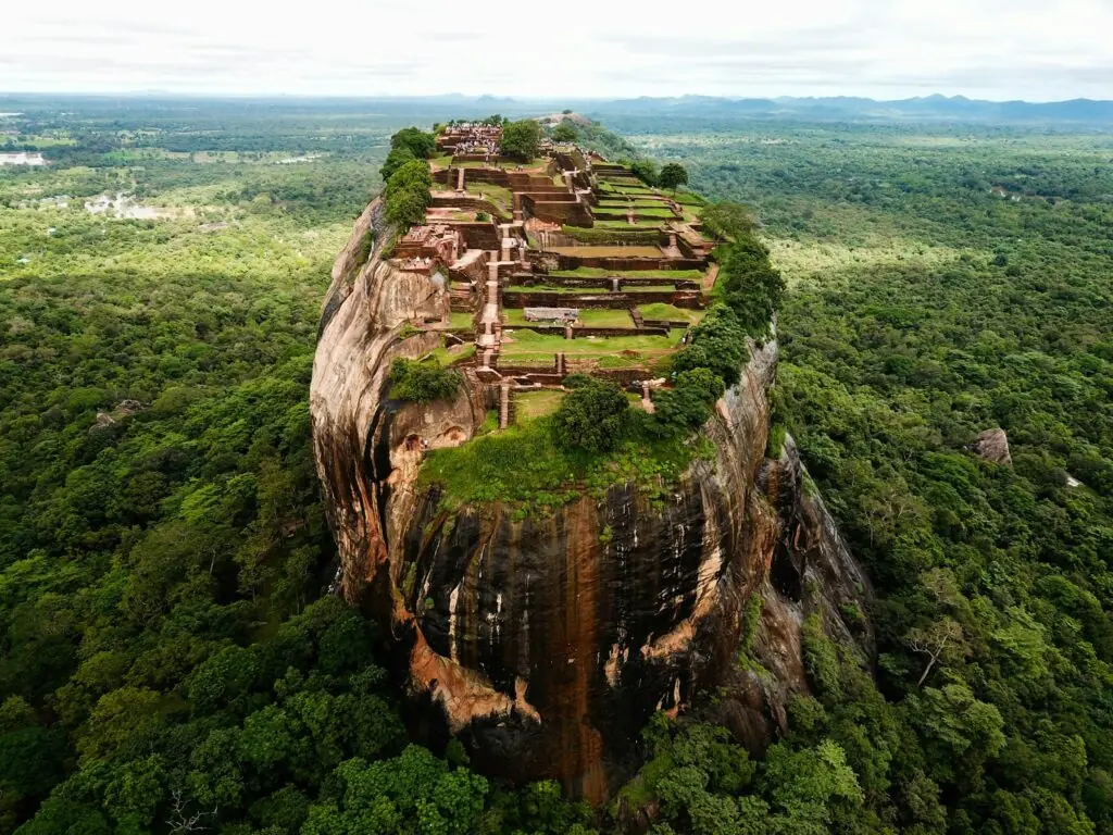 Sri Lanka : Aerial view of the Sigiriya rock fortress rising above a dense green forest